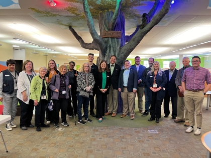 Beloit Public Library group photo under tree in children's area